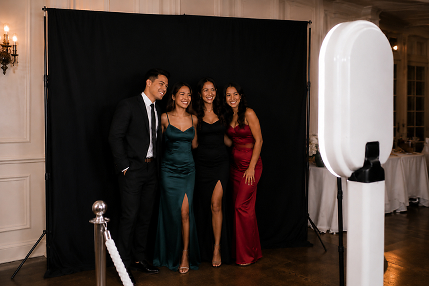 Guests posing at black backdrop